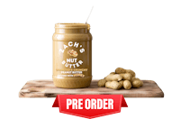 a jar of peanut butter on a wooden cutting board